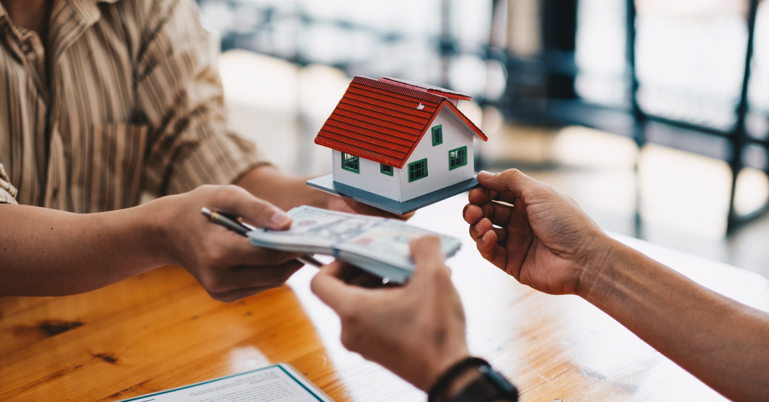 A typical middle class home buyer: the tussle between ‘price sensitivity’ and ‘quality consciousness’ 17 close up of hands giving house model to other hand 2022 08 24 15 41 02 utc scaled