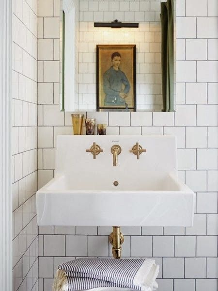White bathrooms with brass fixture 